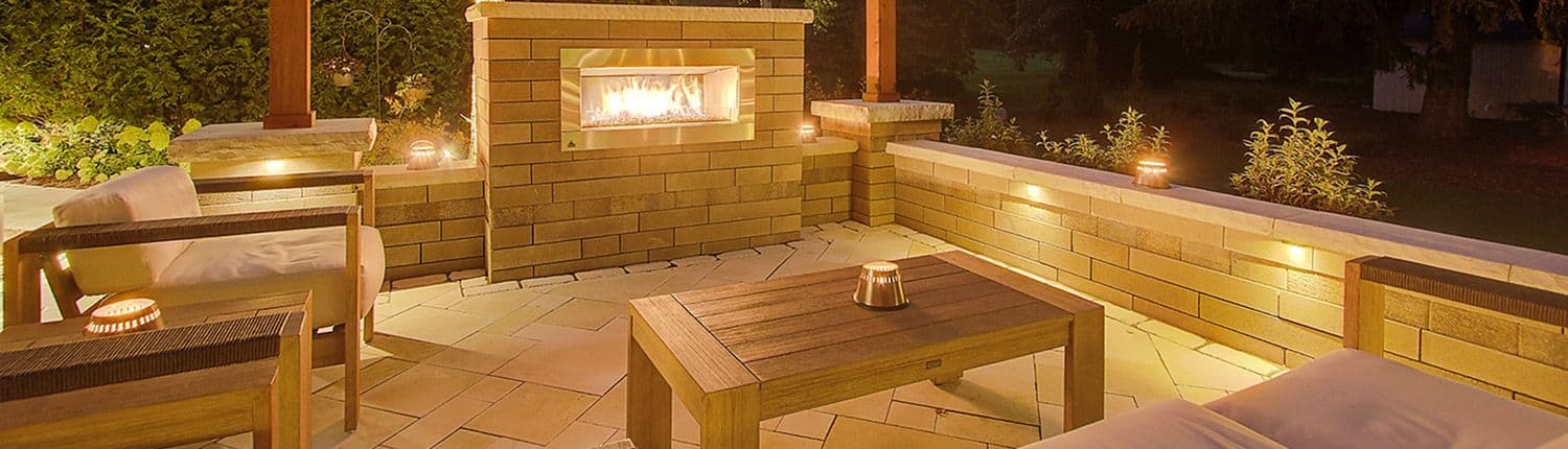 Patio At Night With Lighting & A Fireplace